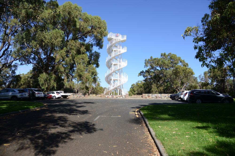 DNA Tower White, double spiral tower with stairs atop a hill.